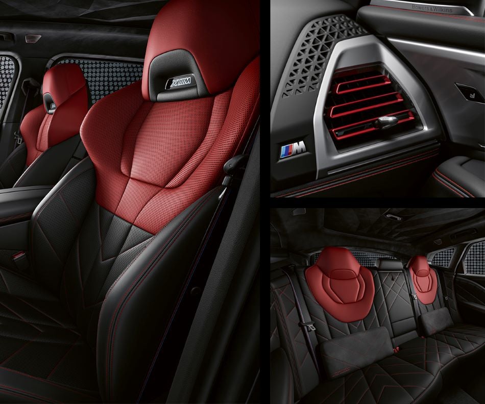 Detail of front seats, clad in exclusive BMW Individual Fiona Red & Black Merino Leather with exclusive M Signature Trim and red stitching and accents. Detail of red accented vent. Detail of rear M Lounge with exclusive XM pillows in BMW of Grand Blanc | Grand Blanc MI